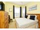 Bright bedroom featuring a large bed, dresser, and natural light from the windows at 2778 Almaton Loop # 403, Kissimmee, FL 34747