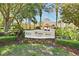A beautifully landscaped entrance to Windsor Hills Clubhouse, surrounded by vibrant flowers and lush greenery at 2778 Almaton Loop # 403, Kissimmee, FL 34747