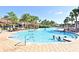 Spacious community pool surrounded by lounge chairs and palm trees, offering a perfect spot for relaxation at 2778 Almaton Loop # 403, Kissimmee, FL 34747