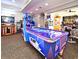 Modern game room with air hockey, arcade basketball, and video game machines at 2778 Almaton Loop # 403, Kissimmee, FL 34747