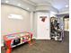 Bright game room with arcade games, including air hockey and Injustice video game at 2778 Almaton Loop # 403, Kissimmee, FL 34747