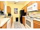 Efficient kitchen featuring essential appliances and ample counter space for meal preparation at 2778 Almaton Loop # 403, Kissimmee, FL 34747