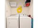 Functional laundry room with washer, dryer, and storage shelf for laundry essentials at 2778 Almaton Loop # 403, Kissimmee, FL 34747