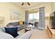 Cozy living room featuring a sofa, stylish decor, and balcony access at 2778 Almaton Loop # 403, Kissimmee, FL 34747