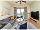 Comfortable living room with a sliding glass door to a balcony with nature views at 2778 Almaton Loop # 403, Kissimmee, FL 34747