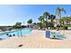 Resort style pool with zero entry, waterslides, palm trees, and lounge chairs at 2778 Almaton Loop # 403, Kissimmee, FL 34747