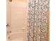 A view of the shower with white tiles and a shower curtain at 2778 Almaton Loop # 403, Kissimmee, FL 34747