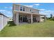 An outdoor covered back porch with furniture overlooks a well-manicured green lawn at 2821 Cathy Blvd, Winter Haven, FL 33880