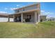 A spacious backyard featuring green grass and a covered patio at 2821 Cathy Blvd, Winter Haven, FL 33880