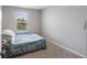 Cozy bedroom with plush carpet, a twin bed, and a window offering natural light and a peaceful atmosphere at 2821 Cathy Blvd, Winter Haven, FL 33880