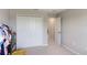 Clean bedroom featuring a bi-fold closet, doorway, and neutral carpet with storage rack at 2821 Cathy Blvd, Winter Haven, FL 33880