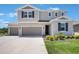 Beautiful two-story home with a three car garage, manicured lawn, and a well-kept garden at 2821 Cathy Blvd, Winter Haven, FL 33880