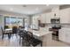 Open-concept kitchen with island, stainless steel appliances, white cabinets, and outdoor view at 2821 Cathy Blvd, Winter Haven, FL 33880