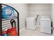 Bright laundry room with modern appliances and a wire rack on the wall and detergent on display at 2821 Cathy Blvd, Winter Haven, FL 33880