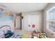Organized room featuring a world map, closet, and toys, bathed in natural light from a large window at 2821 Cathy Blvd, Winter Haven, FL 33880