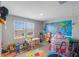 Bright room filled with toys, a world map, and a rocket-themed play area, perfect for playful activities at 2821 Cathy Blvd, Winter Haven, FL 33880