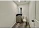 Cozy bathroom with wood-look flooring, a single vanity, and a toilet, all in a neutral color palette at 2831 Magnolia Ave, Sanford, FL 32773
