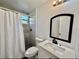 Updated bathroom featuring a modern vanity, mirror, and a tiled shower with a shower curtain at 2831 Magnolia Ave, Sanford, FL 32773