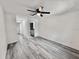 Well-lit bedroom featuring fresh paint, vinyl floors, and a ceiling fan at 2831 Magnolia Ave, Sanford, FL 32773