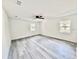 Well-lit bedroom featuring fresh paint, vinyl floors, and two windows at 2831 Magnolia Ave, Sanford, FL 32773
