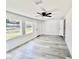 Bright bedroom featuring new paint, vinyl floors, ceiling fan, and natural light from two windows at 2831 Magnolia Ave, Sanford, FL 32773
