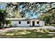 Charming single-story home with a freshly painted white exterior and inviting front yard at 2831 Magnolia Ave, Sanford, FL 32773