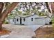 Charming single-story home with a well-manicured lawn, mature trees, and a freshly painted exterior at 2831 Magnolia Ave, Sanford, FL 32773