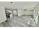 Open concept living room and kitchen featuring vinyl floors, kitchen island, and sliding glass doors at 2831 Magnolia Ave, Sanford, FL 32773