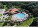 Aerial shot of community pool and clubhouse, showcasing lush landscaping and ample seating at 2901 Puerta Del Sol Blvd, Kissimmee, FL 34744