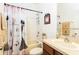 Bathroom with decorative shower curtain, light wood vanity, and well-lit mirror at 2901 Puerta Del Sol Blvd, Kissimmee, FL 34744