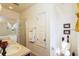 Bathroom featuring a glass-enclosed shower, dual sink vanity, toilet, and linen storage for added convenience at 2901 Puerta Del Sol Blvd, Kissimmee, FL 34744