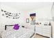 Bright bedroom with a whimsical touch, featuring a cozy bed and ample natural light at 2901 Puerta Del Sol Blvd, Kissimmee, FL 34744