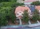 Townhouse with a red tile roof, lush landscaping, and neutral-toned exterior at 2901 Puerta Del Sol Blvd, Kissimmee, FL 34744