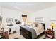 Well-lit bedroom with cozy bed, decorative lamps, and minimalistic decor at 2901 Puerta Del Sol Blvd, Kissimmee, FL 34744