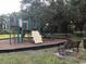 Community playground with slides, climbing structures, and benches under shady trees at 2901 Puerta Del Sol Blvd, Kissimmee, FL 34744
