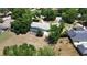 Aerial view of a single-story home with a screened pool, circular driveway, and well-maintained landscaping in a suburban setting at 3328 Wax Berry Ct, Windermere, FL 34786