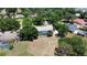 Aerial view of a single-story home with a screened pool, circular driveway, and well-maintained landscaping in a suburban setting at 3328 Wax Berry Ct, Windermere, FL 34786