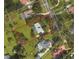 Aerial view displaying a property's boundary lines and location in a neighborhood with mature trees and various home styles at 3328 Wax Berry Ct, Windermere, FL 34786
