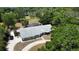 Expansive single-story home with a large screened pool area and spacious yard surrounded by mature trees and lush landscaping at 3328 Wax Berry Ct, Windermere, FL 34786