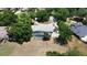 Aerial view of a single-story home with a screened pool, circular driveway, and well-maintained landscaping in a suburban setting at 3328 Wax Berry Ct, Windermere, FL 34786