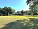 Expansive backyard with mature trees and a screened-in pool enclosure at 3328 Wax Berry Ct, Windermere, FL 34786