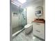 This renovated bathroom features a modern floating vanity, contemporary toilet, and frameless shower at 3328 Wax Berry Ct, Windermere, FL 34786