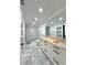 Modern bathroom features dual sinks with wood counters, marble floors, and great lighting at 3328 Wax Berry Ct, Windermere, FL 34786