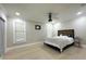 This well lit bedroom features a ceiling fan, hardwood floors, and large windows at 3328 Wax Berry Ct, Windermere, FL 34786