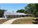 Exterior view of a single-story home with stone accents and a circular driveway at 3328 Wax Berry Ct, Windermere, FL 34786