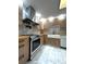 Modern kitchen featuring stainless steel appliances, marble floors, and light wood cabinetry with a farmhouse sink at 3328 Wax Berry Ct, Windermere, FL 34786