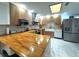 Bright kitchen boasting marble floors, wood countertops, stainless steel appliances and recessed lighting at 3328 Wax Berry Ct, Windermere, FL 34786