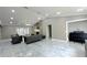 Open living room with fireplace, marble floors, stylish sofas and a seamless connection to a piano room at 3328 Wax Berry Ct, Windermere, FL 34786