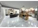 Open-concept living space showcasing a modern kitchen, fireplace, marble flooring and comfortable seating area at 3328 Wax Berry Ct, Windermere, FL 34786