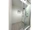 This sleek shower is finished with a frameless door, rainfall shower head, and built in niche at 3328 Wax Berry Ct, Windermere, FL 34786